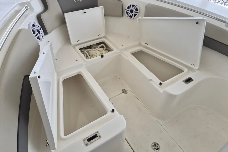 Slide: The Image of Open storage compartments on a 2026 Key West 260 Center Console boat. - 24