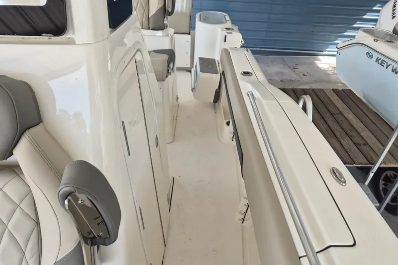 Slide: The Image of 2026 Key West 260 Center Console boat interior with seating and storage compartments. - 25