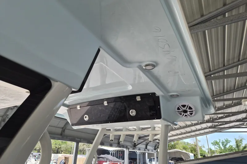 Slide: The Image of 2026 Key West 260 Center Console boat under a metal canopy, featuring speakers and storage. - 26