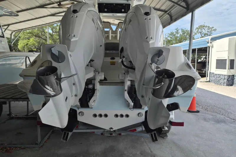 Slide: The Image of 2026 Key West 260 Center Console boat with dual outboard engines in a covered storage area. - 4