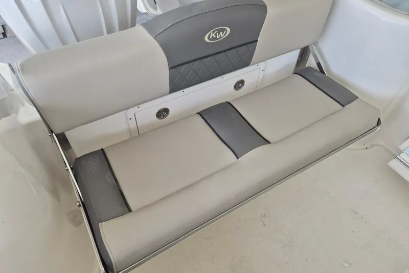 Slide: The Image of 2026 Key West 260 Center Console boat seat, featuring gray and beige cushioned design. - 8