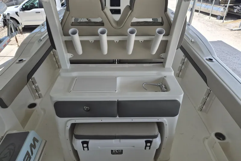 Slide: The Image of 2026 Key West 260 Center Console boat interior with rod holders and storage. - 9