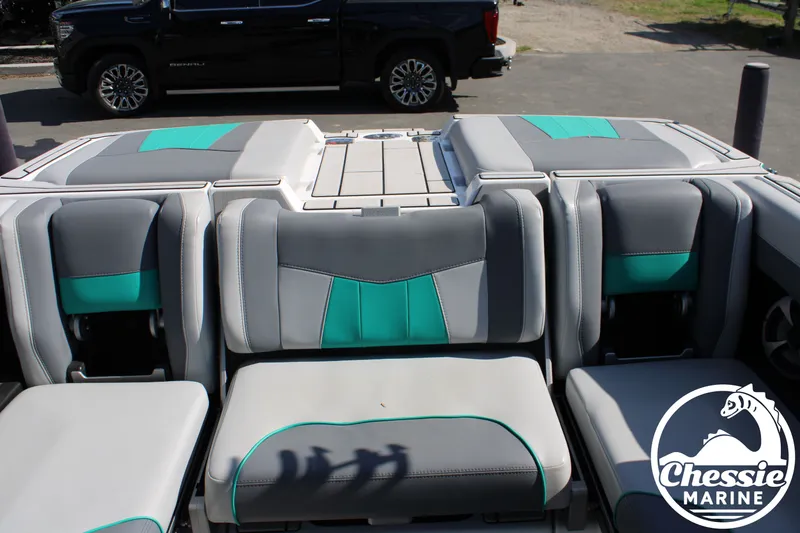Slide: The Image of 2020 Malibu Wakesetter 23 MXZ boat interior with gray and teal seating. - 12