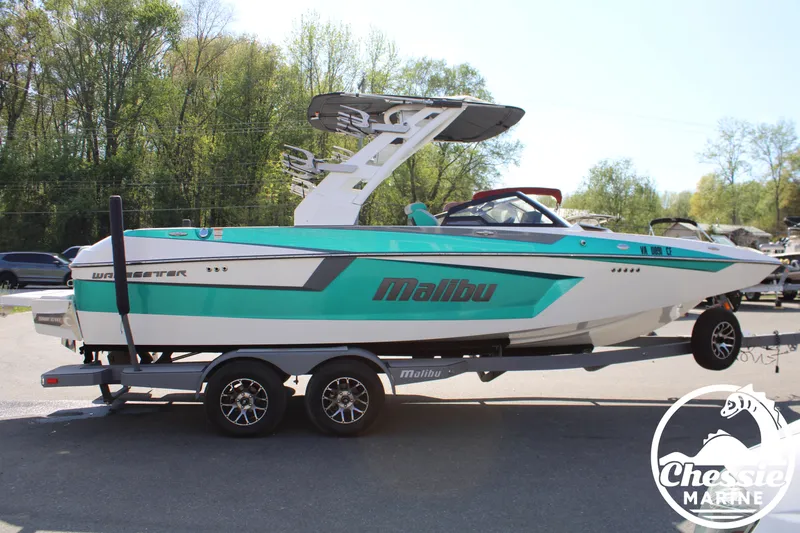 Slide: The Image of 2020 Malibu Wakesetter 23 MXZ boat on trailer, turquoise and white. - 6