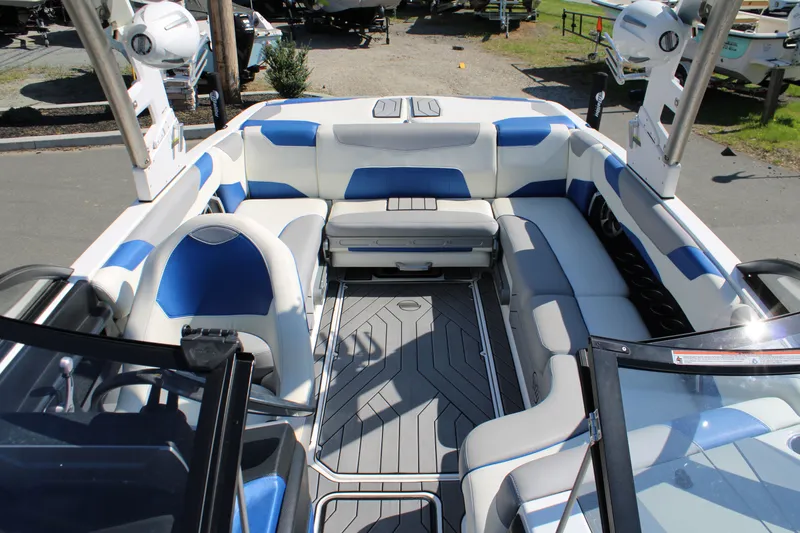 Slide: The Image of Interior of a 2018 Malibu Wakesetter 23 LSV boat with blue and gray seating. - 13