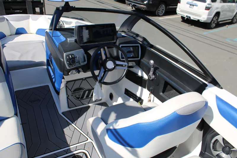Slide: The Image of Interior of a 2018 Malibu Wakesetter 23 LSV boat, blue and white seats. - 17