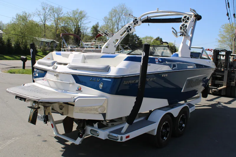 Slide: The Image of 2018 Malibu Wakesetter 23 LSV boat on trailer, blue and white design. - 5