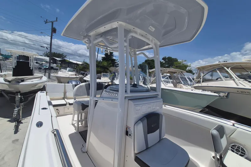 Slide: The Image of 2023 Robalo R230 Center Console boat in a marina under clear blue skies. - 18
