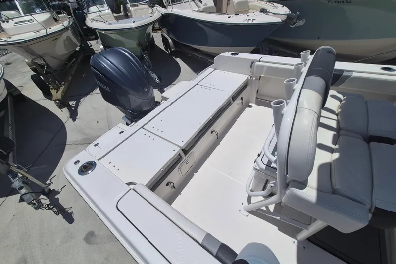 Slide: The Image of 2023 Robalo R230 Center Console boat with Yamaha engine, spacious seating, and rod holders. - 19
