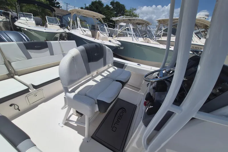 Slide: The Image of 2023 Robalo R230 Center Console boat interior with seating and steering wheel. - 7