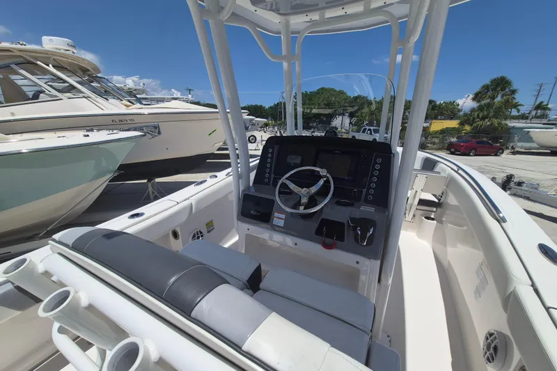 Slide: The Image of 2023 Robalo R230 Center Console boat interior with steering wheel and control panel. - 9