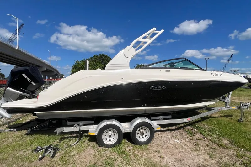 The Image of 2019 Sea Ray SDX 250 Outboard boat on trailer under blue sky. - 0