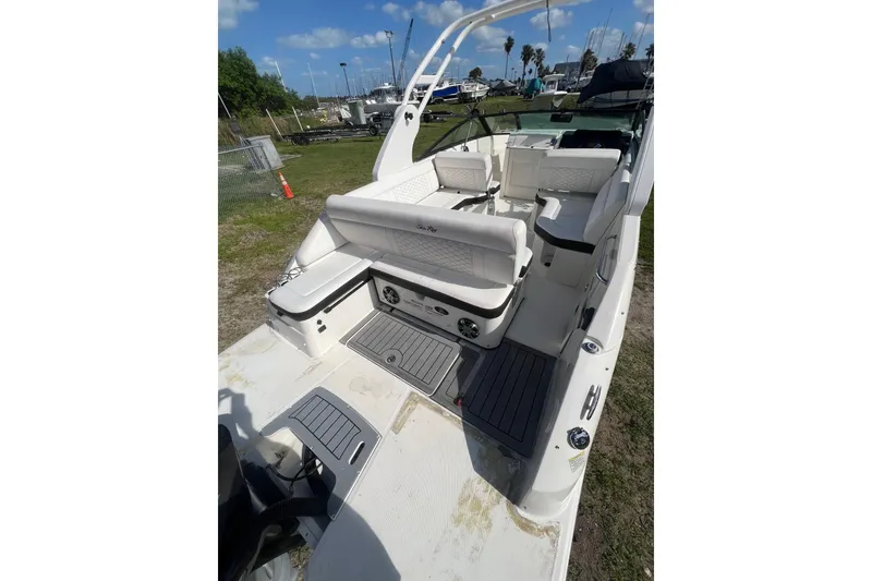 Slide: The Image of 2019 Sea Ray SDX 250 Outboard boat interior with white seating and deck view. - 12