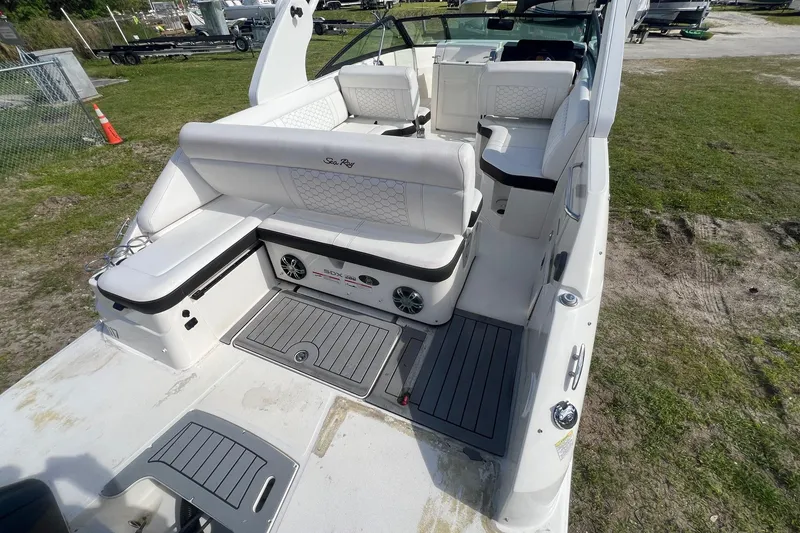 Slide: The Image of 2019 Sea Ray SDX 250 Outboard boat interior with white seating and deck. - 13