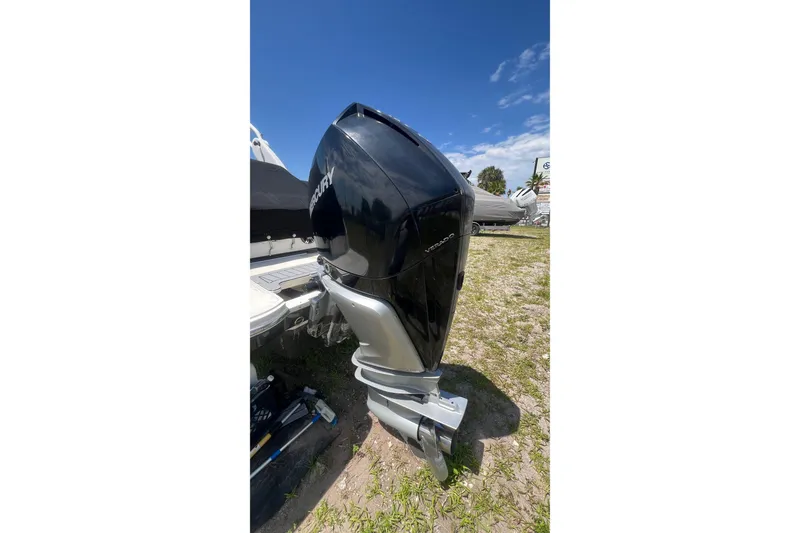 Slide: The Image of 2019 Sea Ray SDX 250 Outboard with Mercury Verado engine, parked on grass. - 21