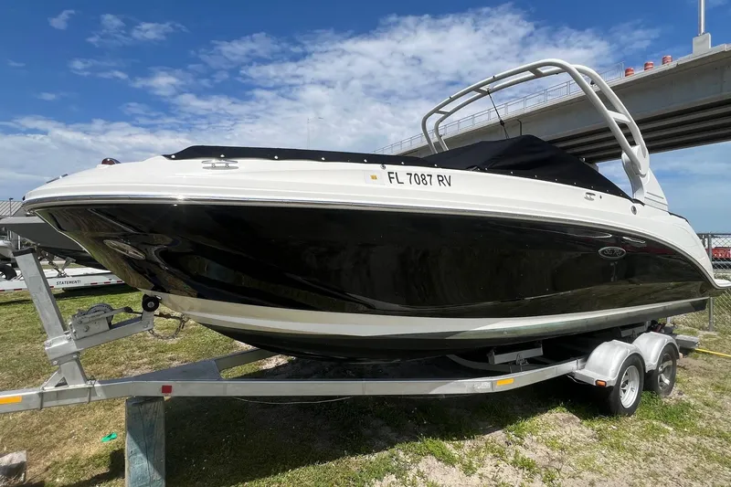 Slide: The Image of 2019 Sea Ray SDX 250 Outboard boat on trailer under a bridge. - 3