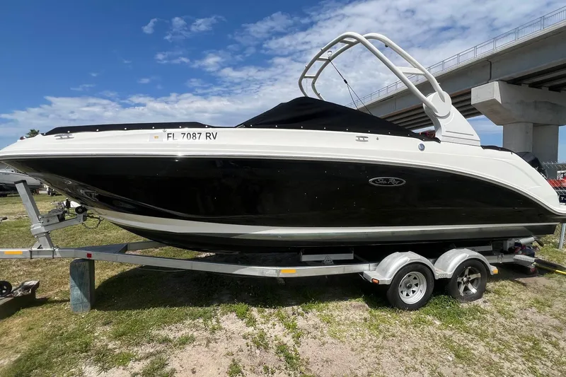 Slide: The Image of 2019 Sea Ray SDX 250 Outboard boat on trailer under blue sky. - 4