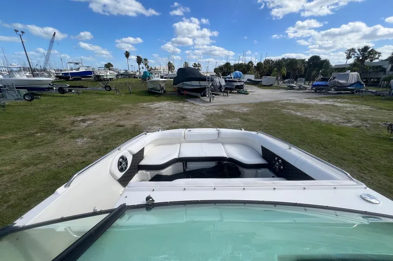 Slide: The Image of 2019 Sea Ray SDX 250 Outboard boat on grassy marina with blue sky. - 7