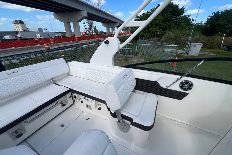 Slide: The Image of 2019 Sea Ray SDX 250 Outboard boat interior with white seating and modern design. - 9