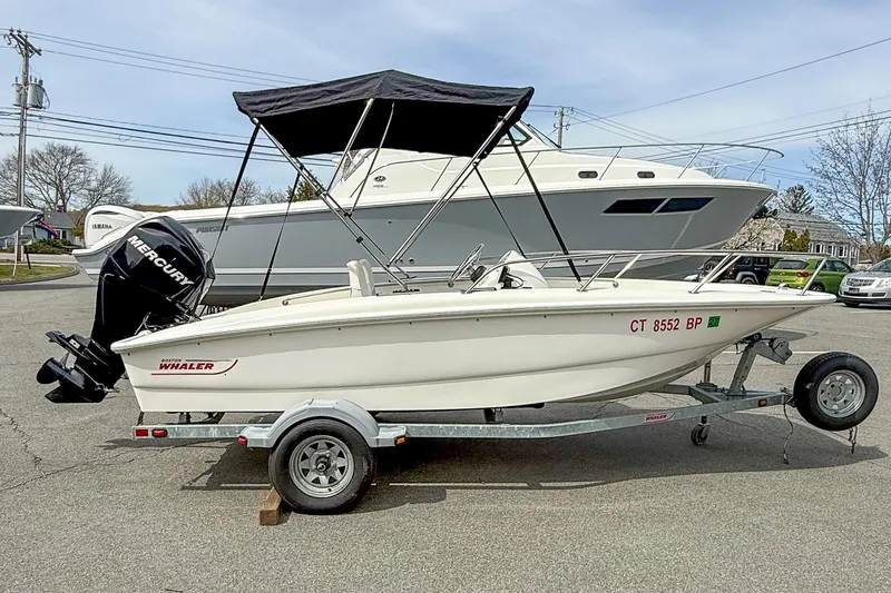 The Image of 2012 Boston Whaler 150 Super Sport boat on trailer with Mercury outboard engine. - 0