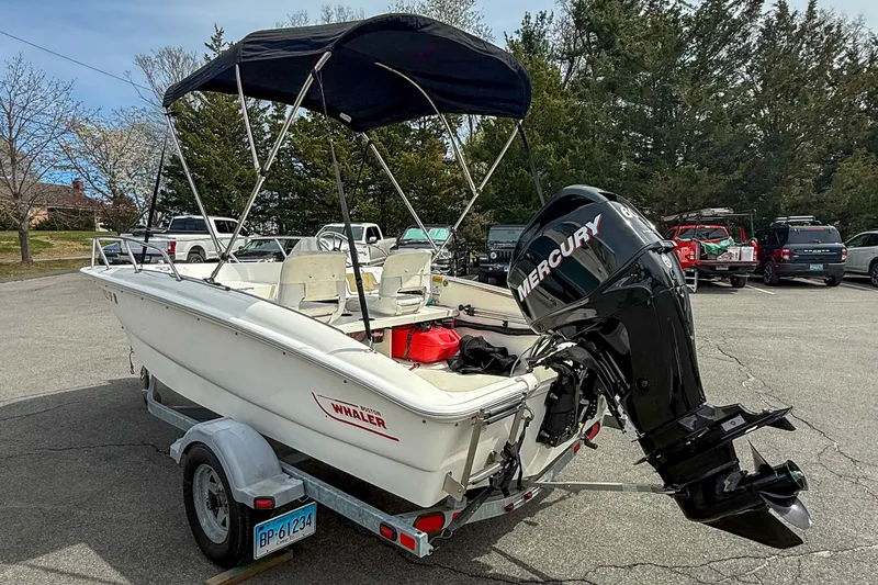 Slide: The Image of 2012 Boston Whaler 150 Super Sport boat with Mercury engine on trailer. - 3