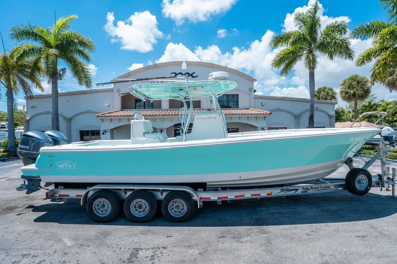 The Image of 2020 Andros 32 Offshore boat on trailer in front of building. - 1