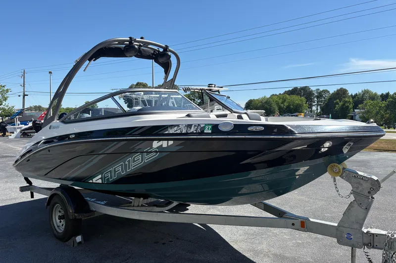 The Image of 2021 Yamaha Boats AR195 on trailer, sleek design, parked outdoors. - 0