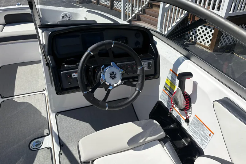 Slide: The Image of 2021 Yamaha Boats AR195 cockpit with steering wheel and control panel. - 11