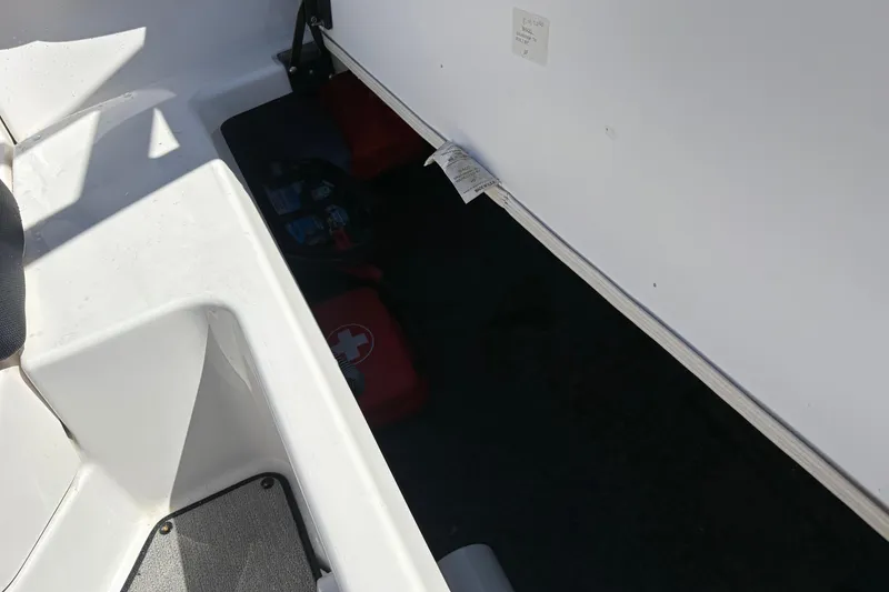 Slide: The Image of Interior storage compartment of 2021 Yamaha AR195 boat, featuring safety equipment. - 19