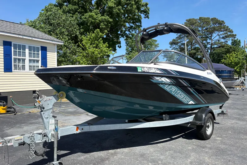 Slide: The Image of 2021 Yamaha AR195 boat on trailer, parked outdoors near a house. - 3