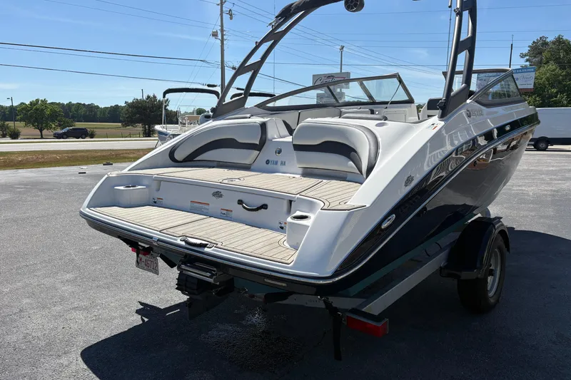 Slide: The Image of 2021 Yamaha Boats AR195 on trailer, showcasing sleek design and spacious seating. - 5