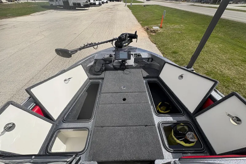 Slide: The Image of 2023 Ranger 2050MS boat deck with storage compartments and fishing equipment. - 13