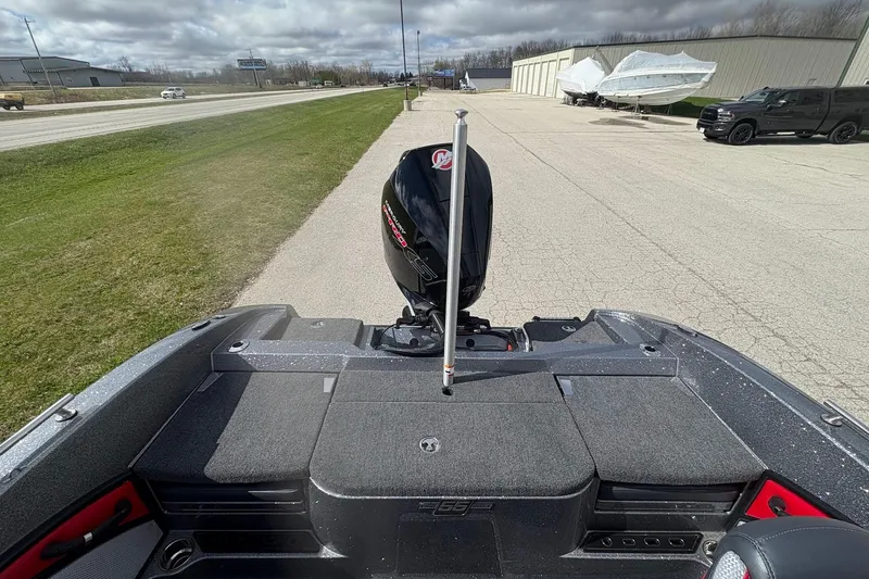 Slide: The Image of 2023 Ranger 2050MS boat with motor, parked near road and storage facility. - 17
