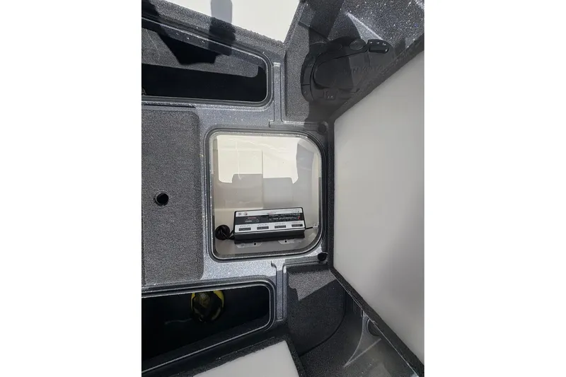 Slide: The Image of Interior view of 2023 Ranger 2050MS boat storage compartment with electronic equipment. - 18