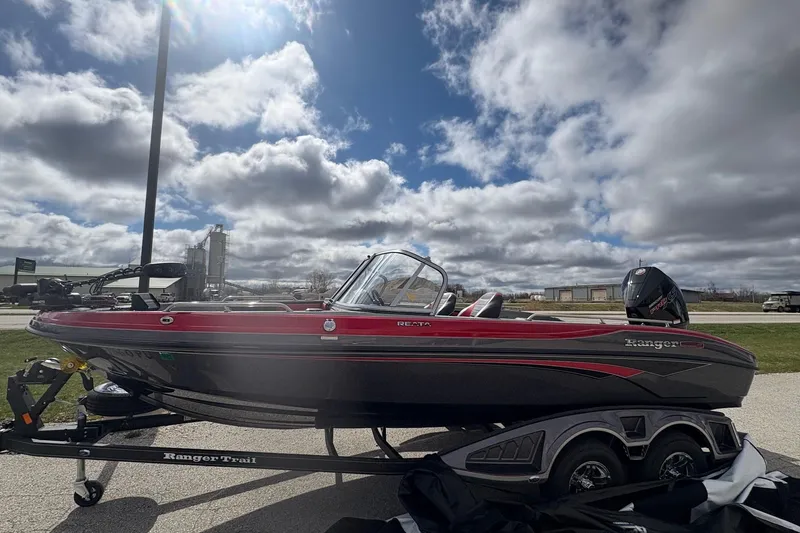 Slide: The Image of 2023 Ranger 2050MS boat on trailer under cloudy sky. - 2