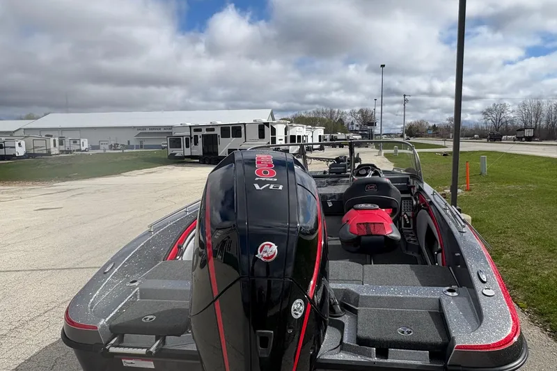 Slide: The Image of 2023 Ranger 2050MS boat with powerful V8 engine, parked outdoors under cloudy skies. - 8