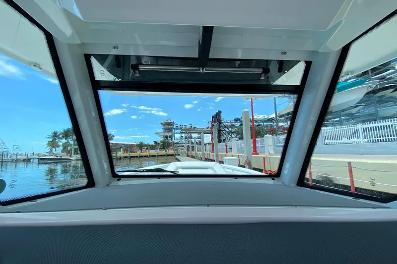 Slide: The Image of View from inside a 2022 Blackfin 332 CC boat at a marina dock. - 11