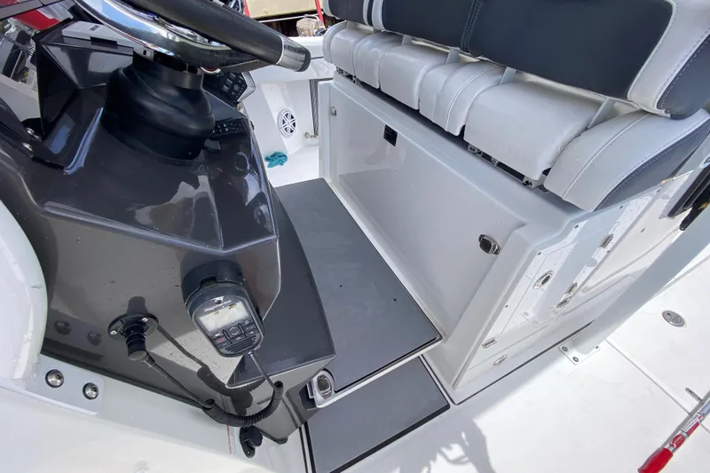Slide: The Image of 2022 Blackfin 332 CC boat interior with steering console and seating area. - 13