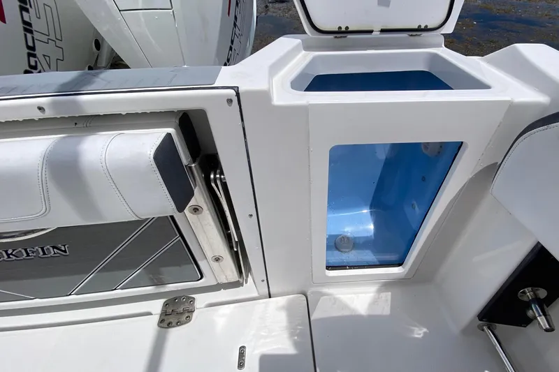 Slide: The Image of 2022 Blackfin 332 CC boat interior with storage compartment and seating detail. - 14