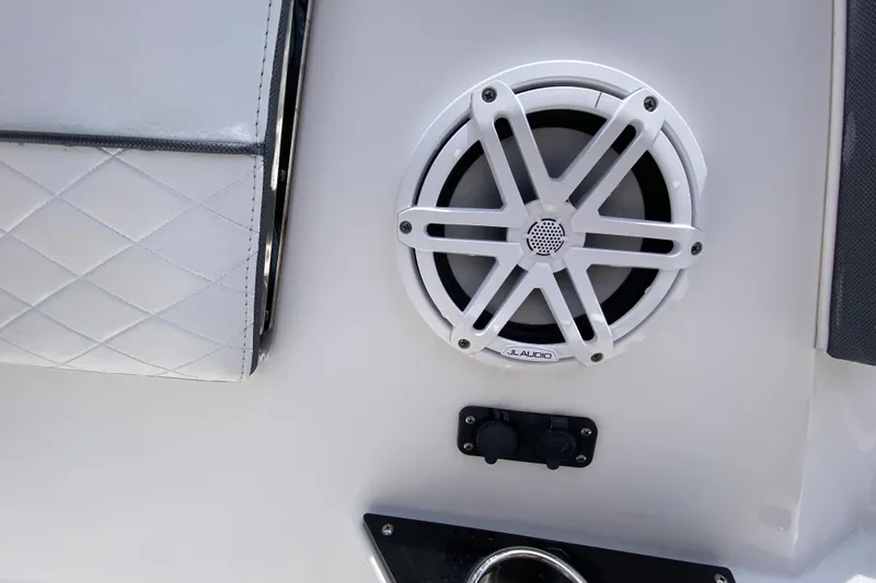 Slide: The Image of 2022 Blackfin 332 CC boat interior featuring JL Audio speaker and quilted upholstery. - 23