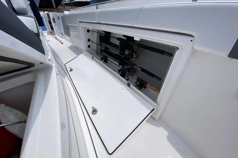 Slide: The Image of 2022 Blackfin 332 CC boat with open fishing rod storage compartment. - 27