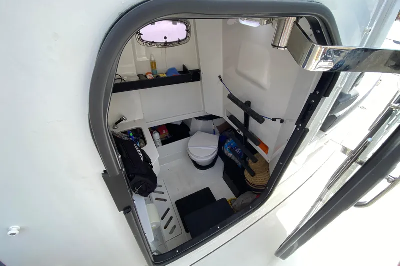 Slide: The Image of Interior view of 2022 Blackfin 332 CC boat cabin with storage and toilet. - 31