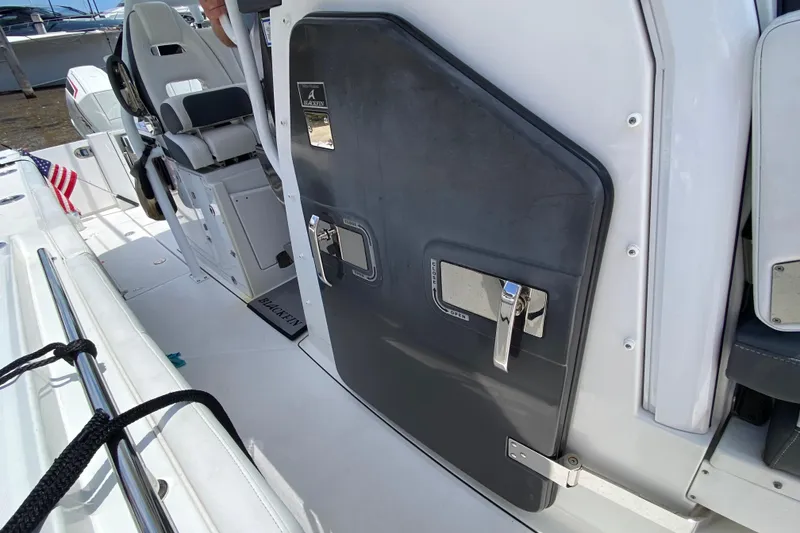 Slide: The Image of 2022 Blackfin 332 CC boat interior with seating and storage compartment. - 32