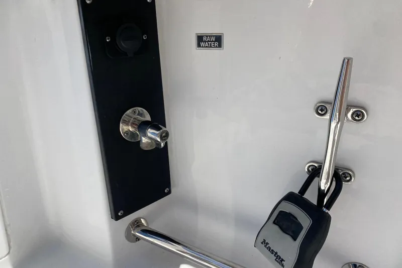 Slide: The Image of 2022 Blackfin 332 CC boat detail with raw water outlet and secured lock. - 35