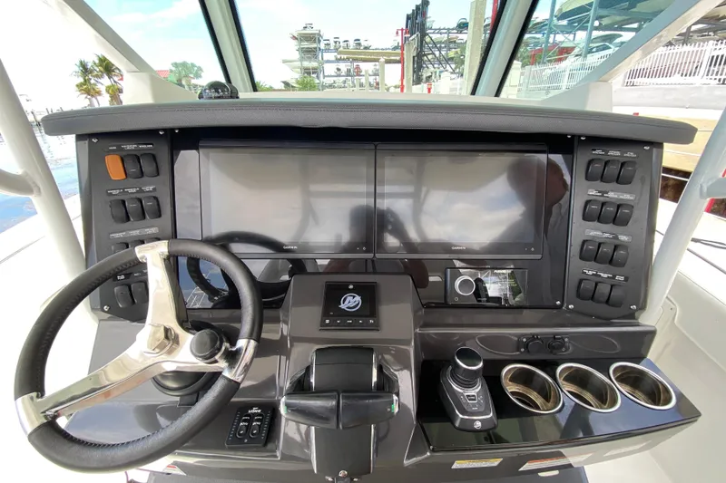 Slide: The Image of 2022 Blackfin 332 CC helm with dual displays, steering wheel, and control panel. - 8