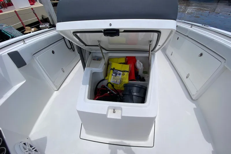 Slide: The Image of Open storage compartment on 2022 Blackfin 332 CC boat, containing various boating supplies. - 26