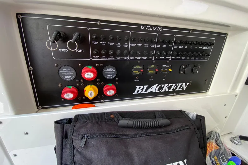 Slide: The Image of Control panel of a 2022 Blackfin 332 CC boat with switches and labels. - 33