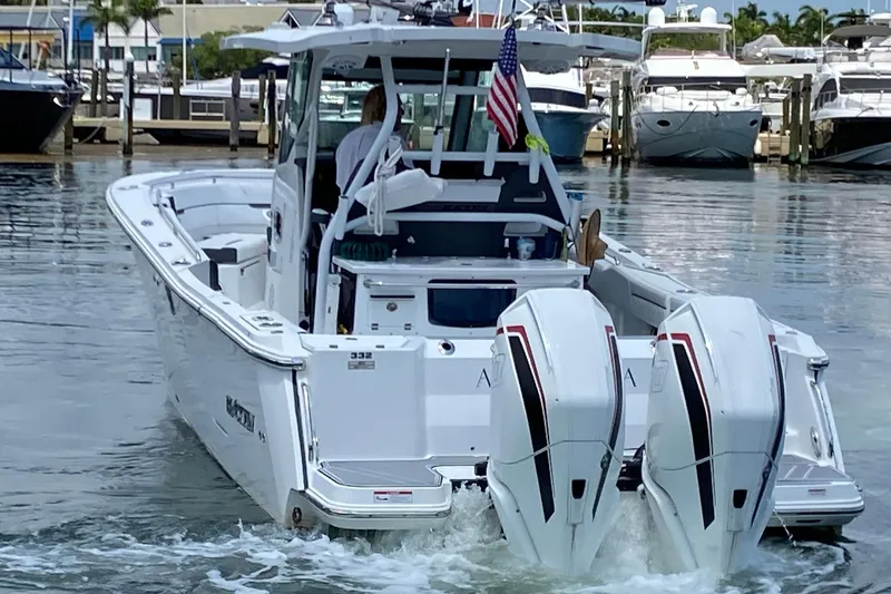 Slide: The Image of 2022 Blackfin 332 CC boat with dual engines docked at a marina. - 4