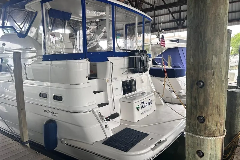 The Image of 2001 Cruisers Yachts 3750 Motoryacht docked in a marina, featuring a sleek white design. - 0