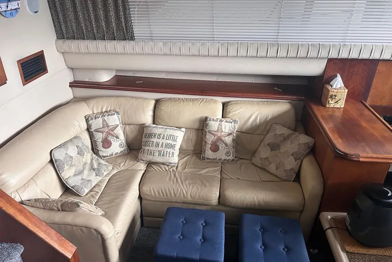 Slide: The Image of 2001 Cruisers Yachts 3750 Motoryacht interior with beige leather seating and decorative pillows. - 12